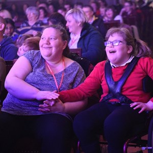 Two attendees at a previous Relaxed Schools Panto looking at the stage